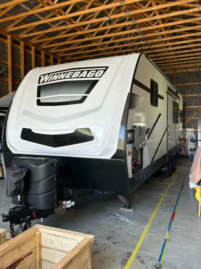 2023 Winnebago Travel Trailer, Model 2529RG, 25-30 feet long, tandem axle. We bought this trailer ne...
