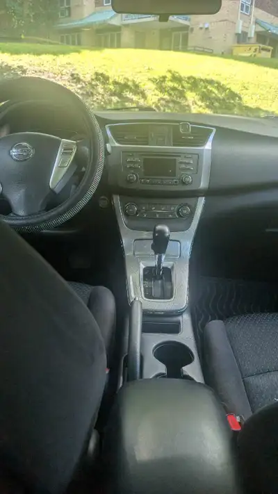 I am selling a Nissan Central that is in used condition. It features a white exterior and a comforta...
