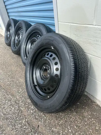 Set of four 205/60r16 92H Firestone FT140 all season tires on OEM 4x100 factory rims for Nissan Kick...