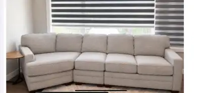 In excellent used condition. It’s a large comfortable fabric sectional. Oyster in colour with deep s...