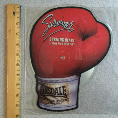 This is a 1985 UK Import 45 RPM Special Single in the Shape of A Boxing Glove Side A : Burning Heart...