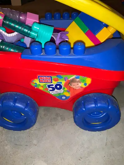 Colourful plastic pull wagon made for the little ones. It is full of megablox plus extra creative bl...