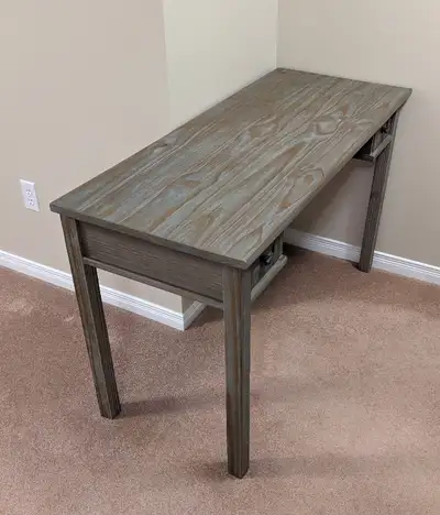 Solid pine wood desk. Measures 48" wide by 20" deep by 28.5" high. It has two pull out drawers and a...