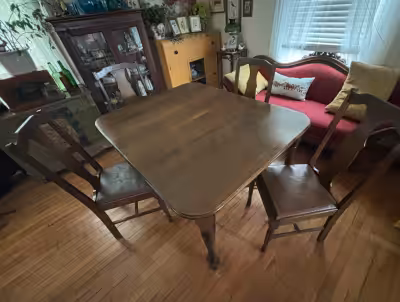 Walnut dining table with original 4 leather seated chairs. Comes with an 8” extention insert. 49” x...