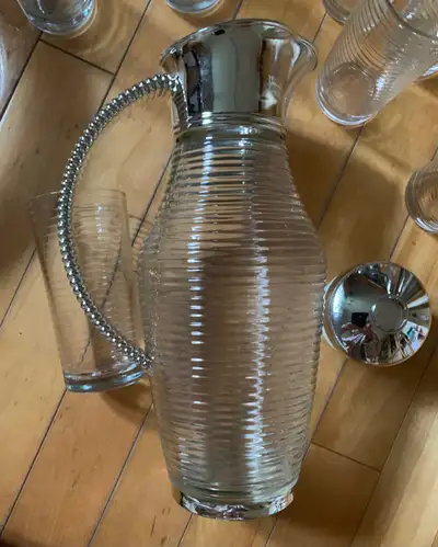A set of glass ribbed pitcher a bowl and 16 tall glasses $45
