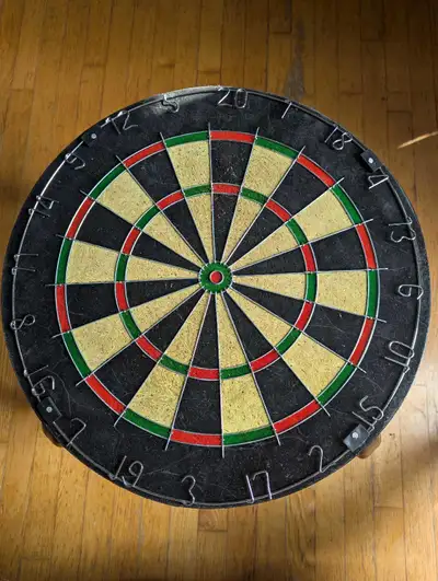 Heavy .used .dart board.no name on it.