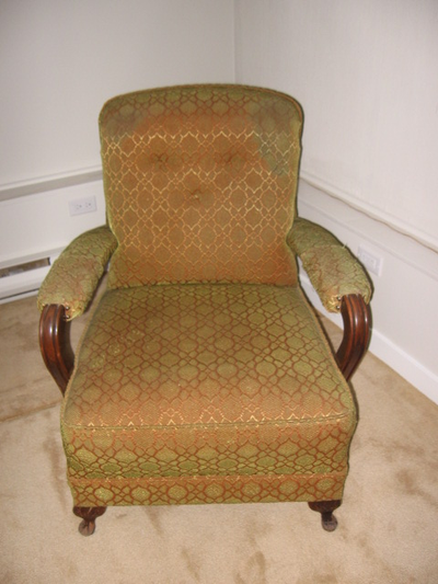 This Chair stands on wooden legs & has wood from the end of the Arms & runs down the side of the cha...