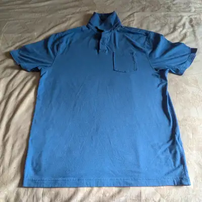 Men's UA Blue Polo Shirt, features front pocket. Size is medium.