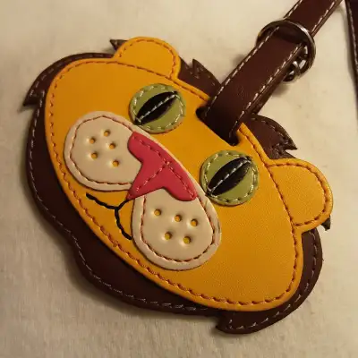 1990s stitched leather Green Eyed Protector Lion luggage tag, View more
