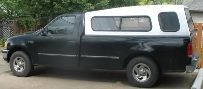 White truck topper for an 8 foot box (Range Rider). - 68" wide. - 99.5" long at the bottom. - Fits F...