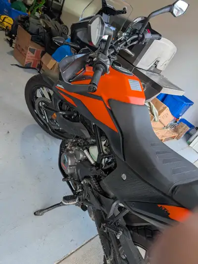 The used KTM 390 Adventure motorcycle offers a blend of on-road comfort and off-road capability, fea...