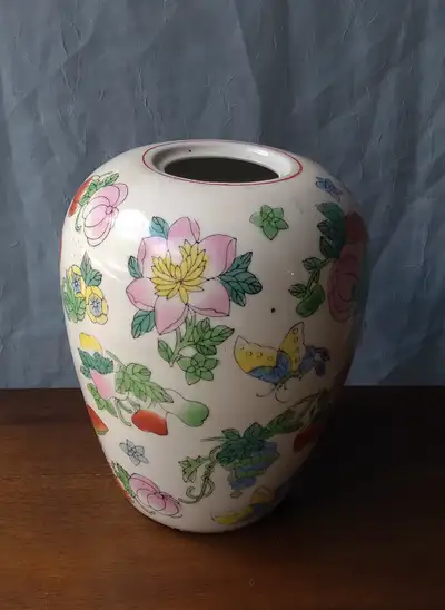 This Chinese porcelain vase is thoroughly covered with images of fruits, flowers and butterflies, in...