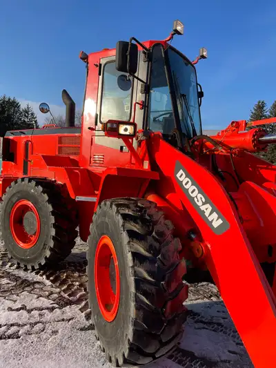 am selling a Doosan wheel loader that is in used condition, perfect for heavy lifting and moving mat...