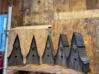Individual birdhouses custom made from dated barnboard and rustic steel. Each house roughly 22” high