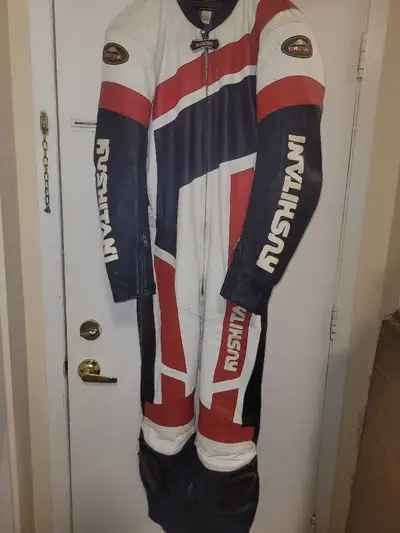 This is a Kushitani motorcycle suit, providing full body protection with integrated armour, size USA...