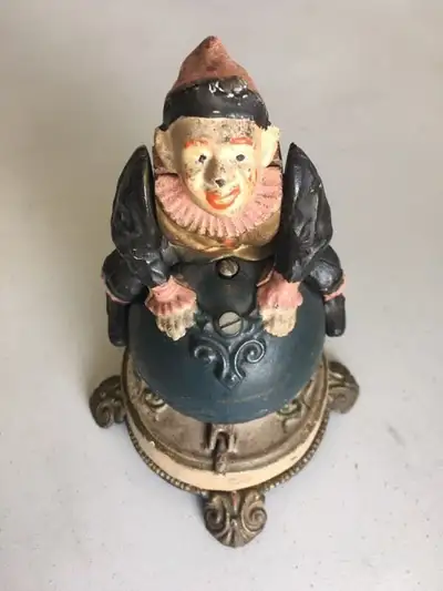 Vintage Cast Iron Mechanical Bank - Clown on Globe, View more