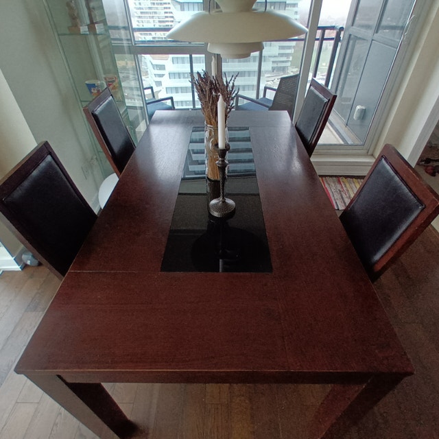 Dark wood Dining Table with black glass table top, 4 chairs. Dining
