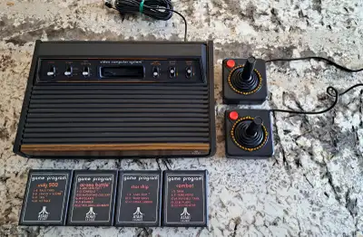 Atari 2600 game console, comes with 2 joystick, 4 games and power supply not shown (850ma, 9V). Was...