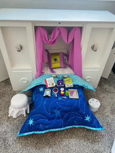 American Girl 3 in 1 Murphy bed and Dream Big Bedding. In good used condition. I believe it has most...