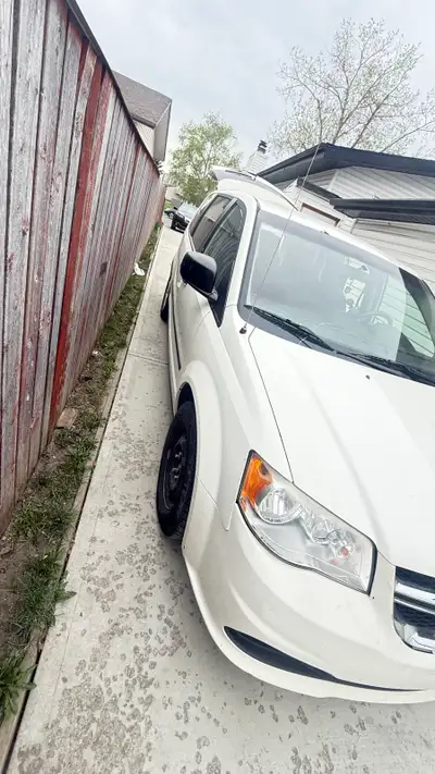 This is a 2012 Dodge Caravan, a reliable minivan ready to haul your family and cargo, with 243968 km...