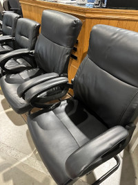 Black leather high back  chair with arms, sled bottom