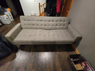 Used Futon from the Brick. Has a slight tear in the stitching on one cushion. Make me an offer.