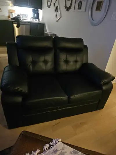 This is a stylish black loveseat, perfect for a smaller living space or as an accent piece. This lov...