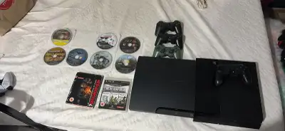  selling a PS3 console with three controllers and 14 games, View more