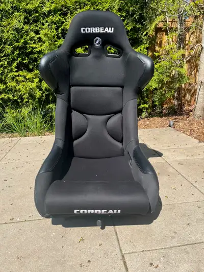 This Black Corbeau racing seat has a durable cloth upholstery with leather-like reinforcements on hi...
