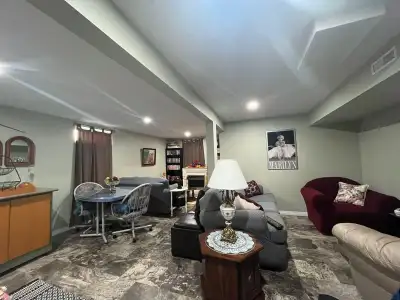 Fully Furnished Suite Open concept includes reading room with fireplace, kitchen, living room. Kitch...
