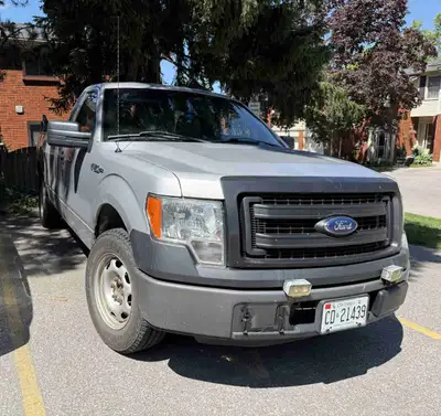 This is a used 2014 Ford F-150 work truck with an 8-foot bed, perfect for any job site or heavy-duty...
