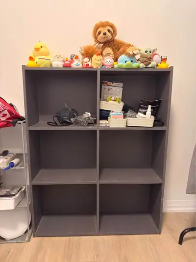 Dark gray 6-cube storage organizer is made of wood composite. This unit has a vertical orientation w...