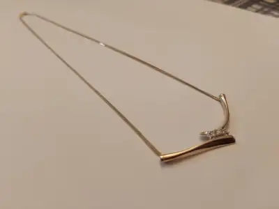 Yellow gold diamond necklace three real diamonds. Stamped 10K..., View more