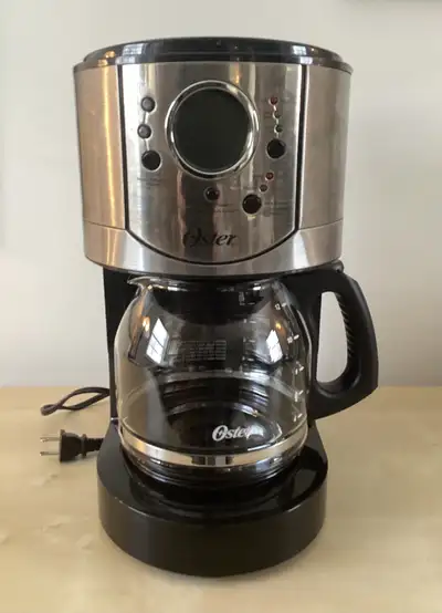 This is the Oster 12-cup programmable coffee maker model BVSTCJ0029-033. The original box and user m...