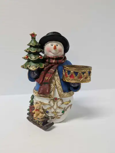 The Snowman is in great vintage condition and he is wearing a blue winter jacket and a striped red s...