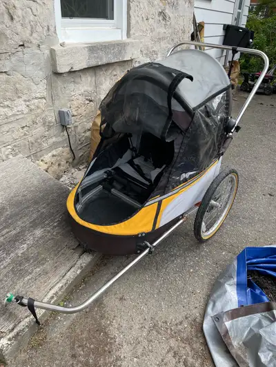 This is a used Wike double trailer/running stroller perfect for taking two kids on bike rides or jog...