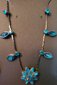 Dark Turquoise crystal flower on black metal chain necklace. 