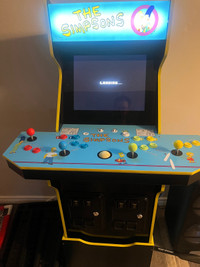 The Simpsons arcade 1up machine with riser