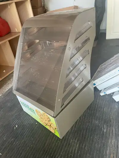 This is a used cookie display rack, perfect for showcasing your delicious treats! It has a few cosme...