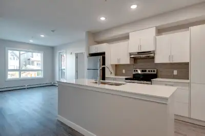 OFFERING NOW TOP FLOOR UNITS    1403 26A ST SW.