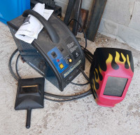 Mig-welder with face mask and helmet 