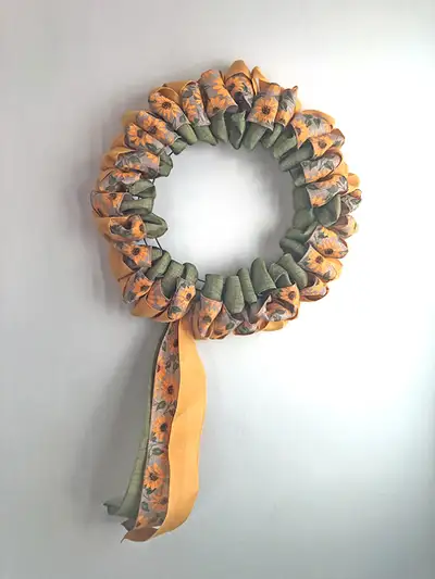This 14” sunflower ribbon wreath declares the essence of summer with the energy of the yellow sunshi...