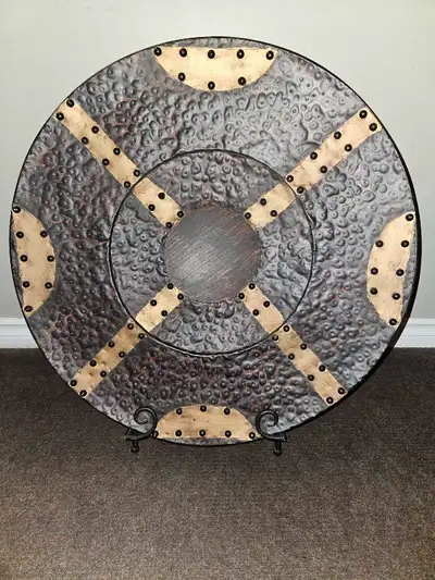 Bought at auction. Was described as a plate but it's more like a shield. Comes with a folding metal...