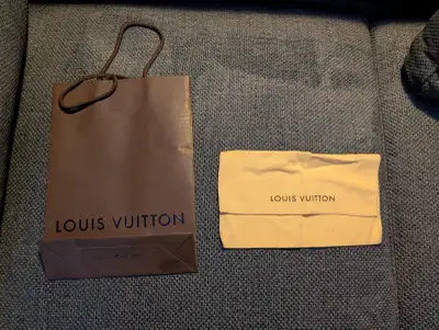 Authentic Louis Vuitton linen cloth dust bag and paper shopping bag. Great condition. Paper shopping...