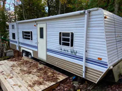 Kingsport K27 camper includes front bedroom, back bunks, convertible beds. Some areas are showing th...