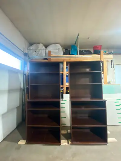 Matching pair of sturdy dark wood shelving units., View more