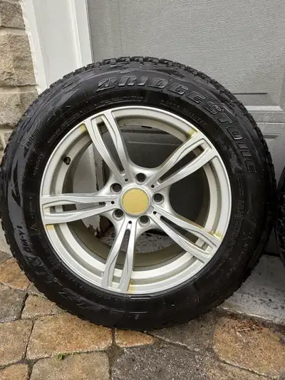I'm selling a set of four winter tires, size 235/65R17, mounted on rims, providing reliable traction...