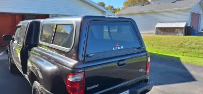 Leer fiberglass truck cap, black, currently installed on a 2003 Ford Ranger Step Side pick up. Fits...
