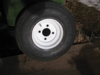 5.70-8 Carlisle sport trail trailer tire (unused) and 4 bolt rim. Tire has not cracks,cuts or holes...