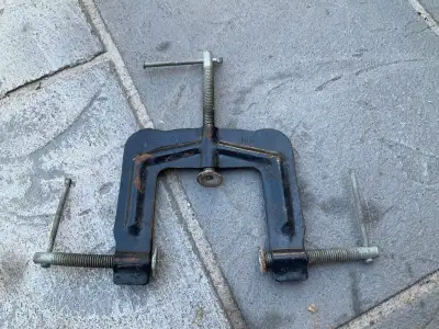 This is a sturdy, cast-iron valve spring compressor designed for automotive engine repair, specifica...